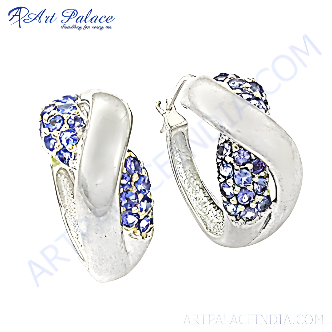 Silver hoop earrings with sparkling blue gemstones. A stunning and elegant jewelry piece.