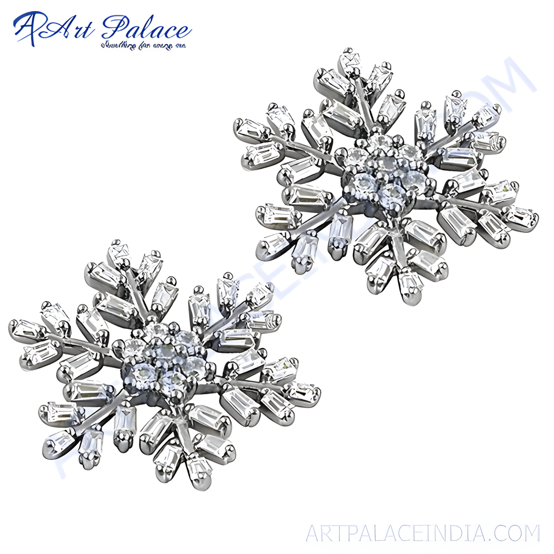 Silver snowflake stud earrings with sparkling cubic zirconia gemstones. A winter-themed, elegant jewelry design.