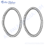 Load image into Gallery viewer, Silver oval hoop earrings with sparkling diamonds on a white background, showcasing elegant women&#39;s jewelry.
