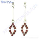 Load image into Gallery viewer, Silver drop earrings with a rhombus shape adorned with pink gemstones.
