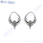 Load image into Gallery viewer, Sterling silver hoop earrings with intricate tribal design, suitable for women, showing high shine and detail.
