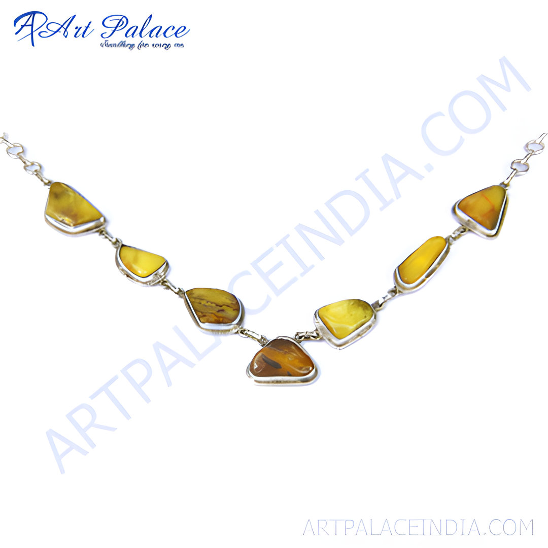Silver necklace with natural amber gemstones, featuring yellow and brown colors in a unique pendant design.