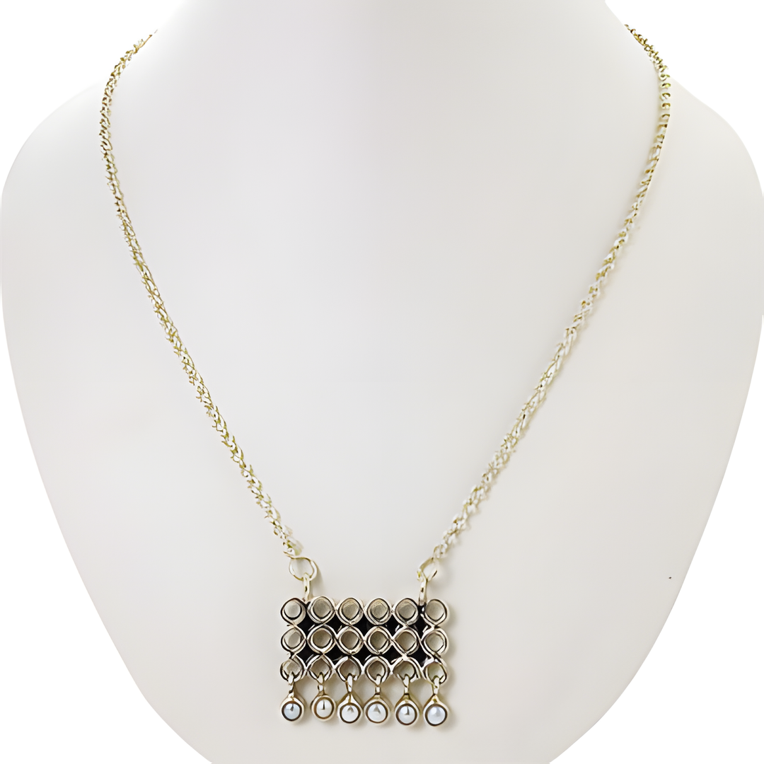 Silver geometric pendant necklace on a white mannequin. Featuring a chain and hanging pendant.