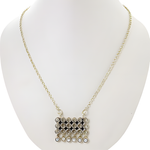 Load image into Gallery viewer, Silver geometric pendant necklace on a white mannequin. Featuring a chain and hanging pendant.
