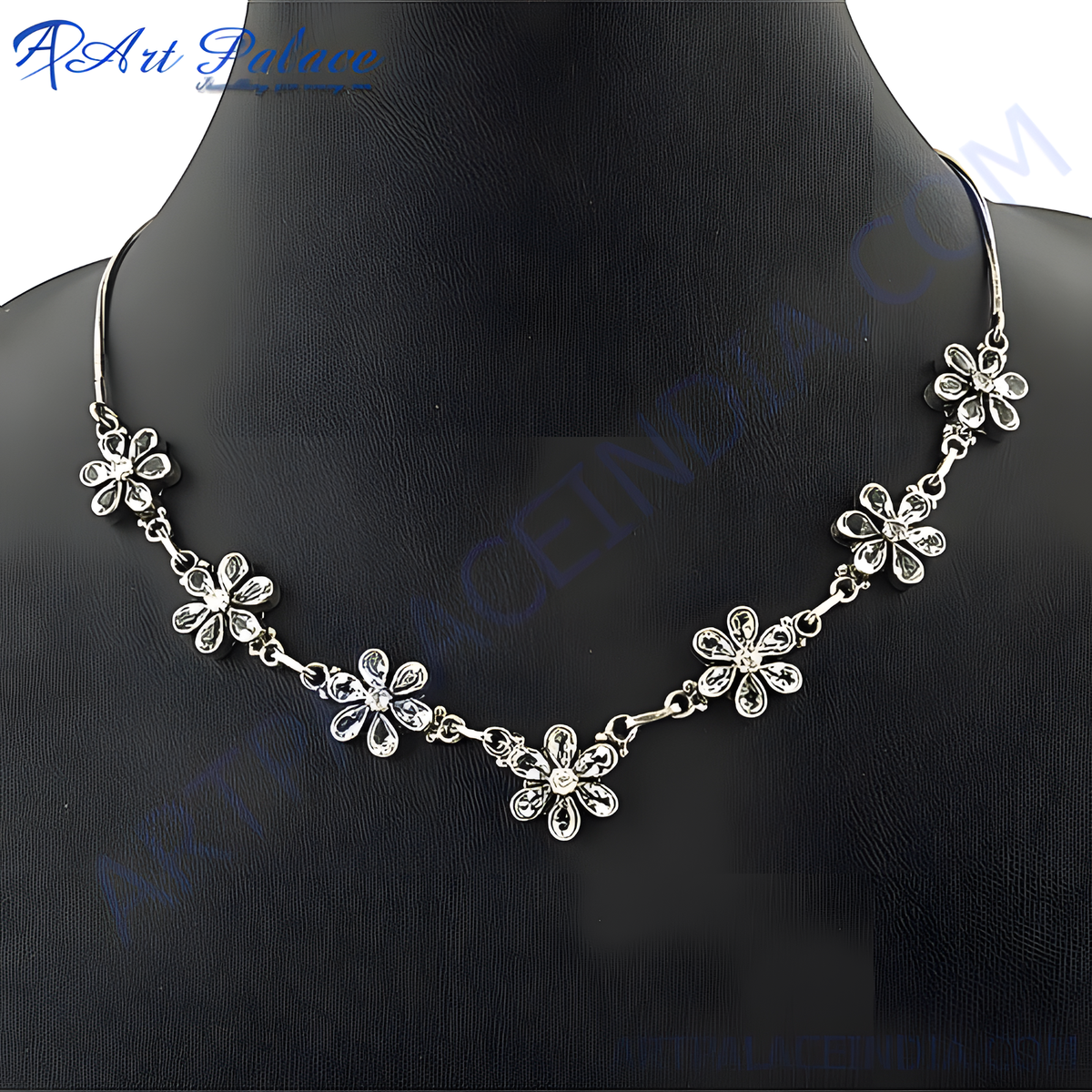 Silver floral necklace with sparkling crystals on a black mannequin