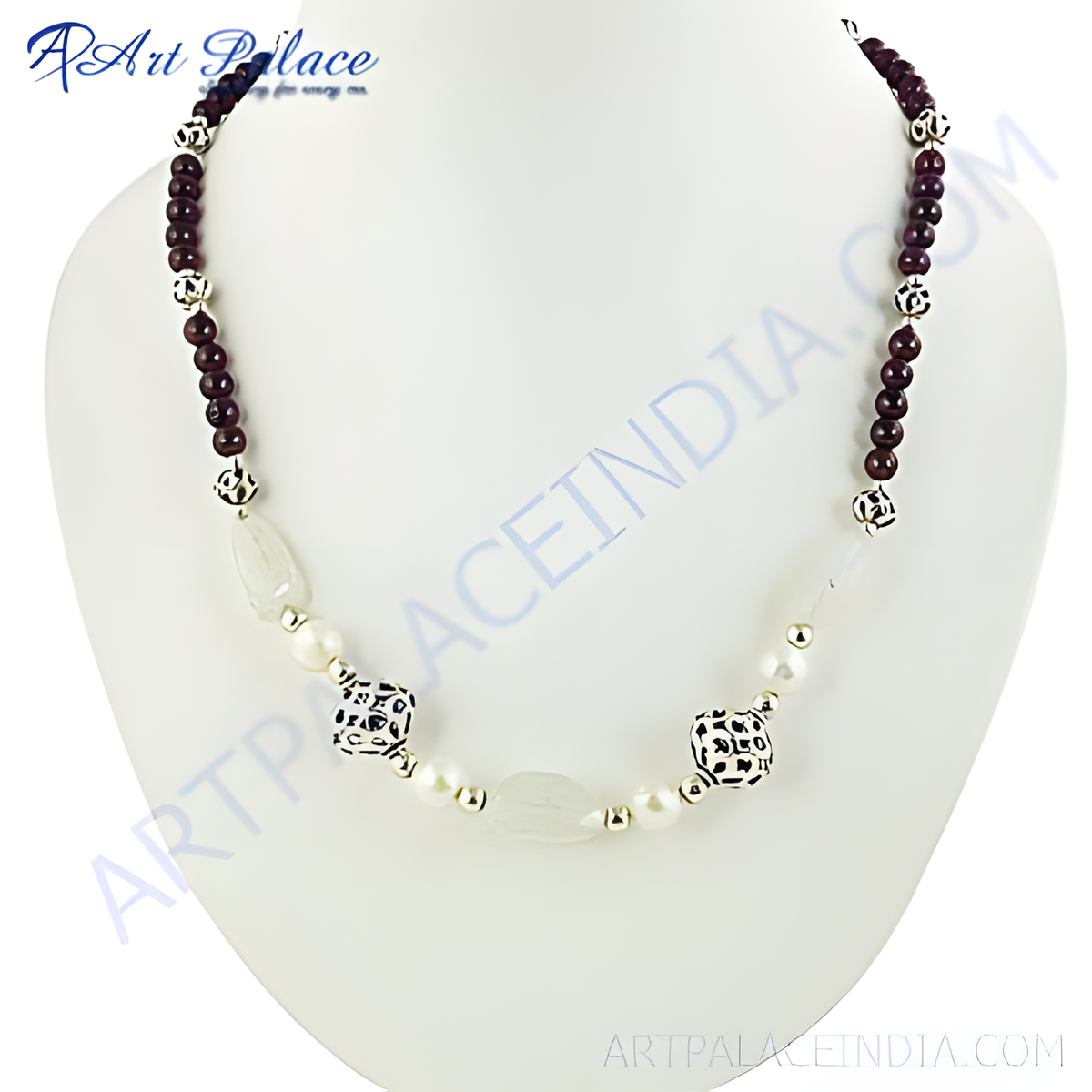 A beaded necklace with a combination of gemstones and silver accents on a white jewelry display