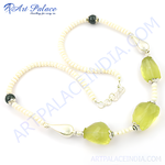 Load image into Gallery viewer, A lime green gemstone bead necklace with white beads on a white surface.
