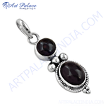 Load image into Gallery viewer, Sterling silver pendant featuring two oval and round dark red garnet gemstones set against a white background.
