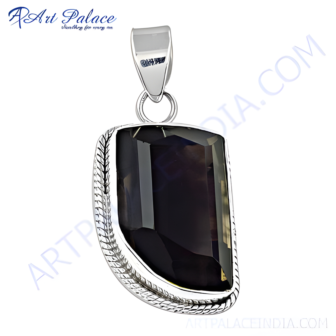 Sterling silver pendant with a faceted smoky quartz gemstone. A dark, translucent stone in a silver setting.
