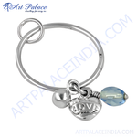 Load image into Gallery viewer, Silver heart charm keychain with LOVE inscription and blue gemstone drop.
