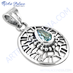 Load image into Gallery viewer, Sterling silver pendant with a pear-shaped blue topaz gemstone in a detailed openwork design.
