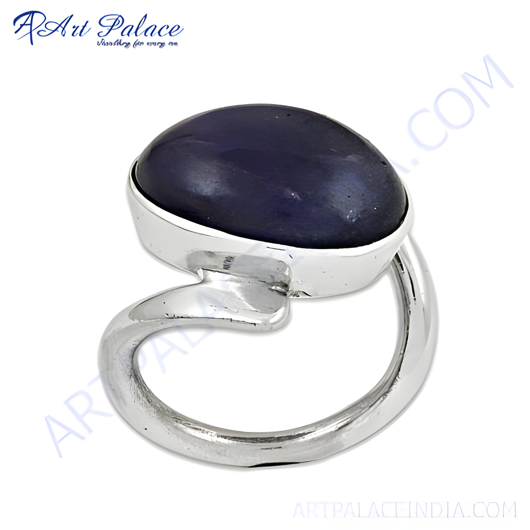 Sterling silver ring featuring an oval-shaped, dark blue gemstone; a stunning piece of jewelry.