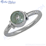 Load image into Gallery viewer, Sterling silver ring with a round, green gemstone set in a knot design.
