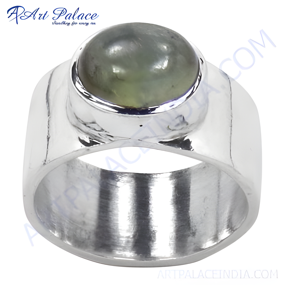 Sterling silver ring with a large, round green gemstone in a polished setting.