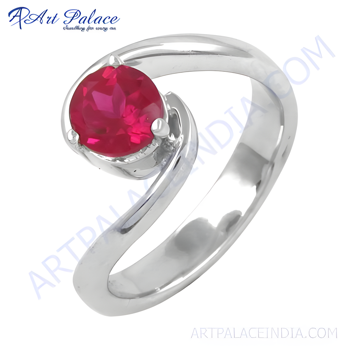 Sterling silver ring with a round, vibrant red ruby gemstone set in a swirl design