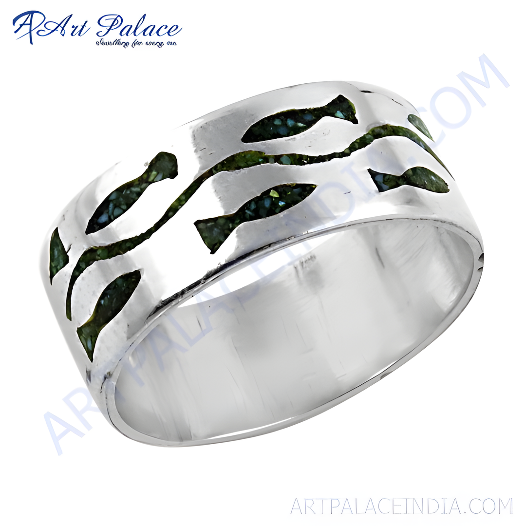 Sterling silver ring with a fish design in green.
