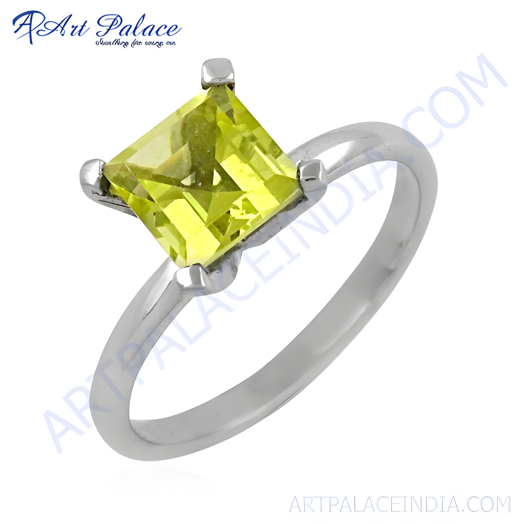 Sterling silver solitaire ring with a square-cut peridot gemstone in a vibrant green hue.