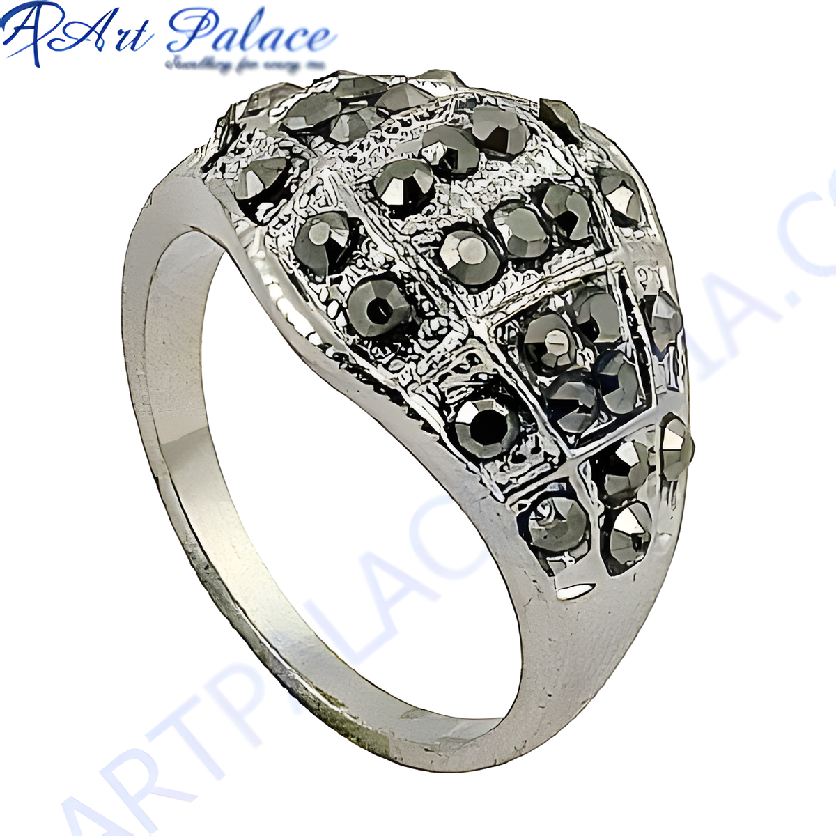 Close up view of a silver marcasite ring with black gemstones, set in a silver band
