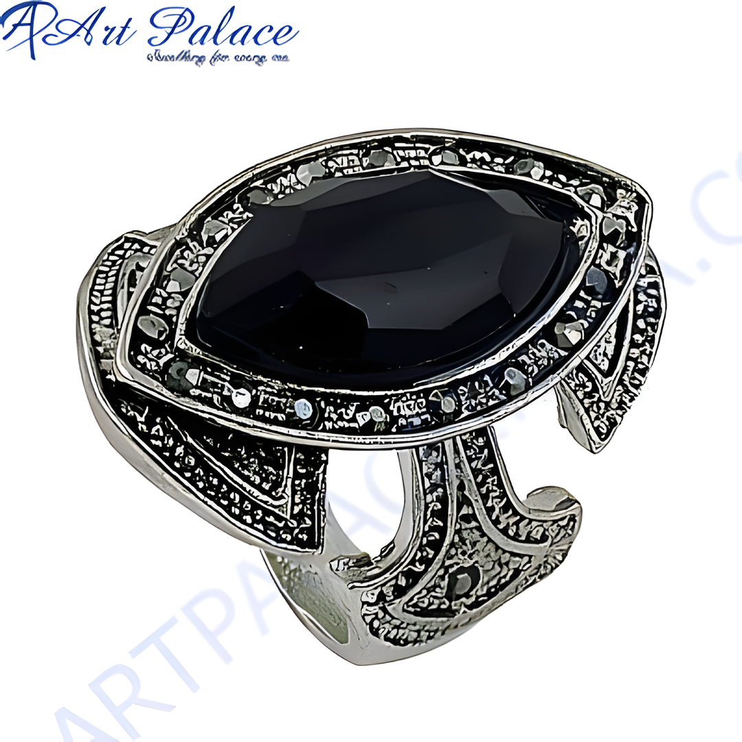 Silver statement ring with a large black onyx gemstone, showcasing intricate design and craftsmanship.