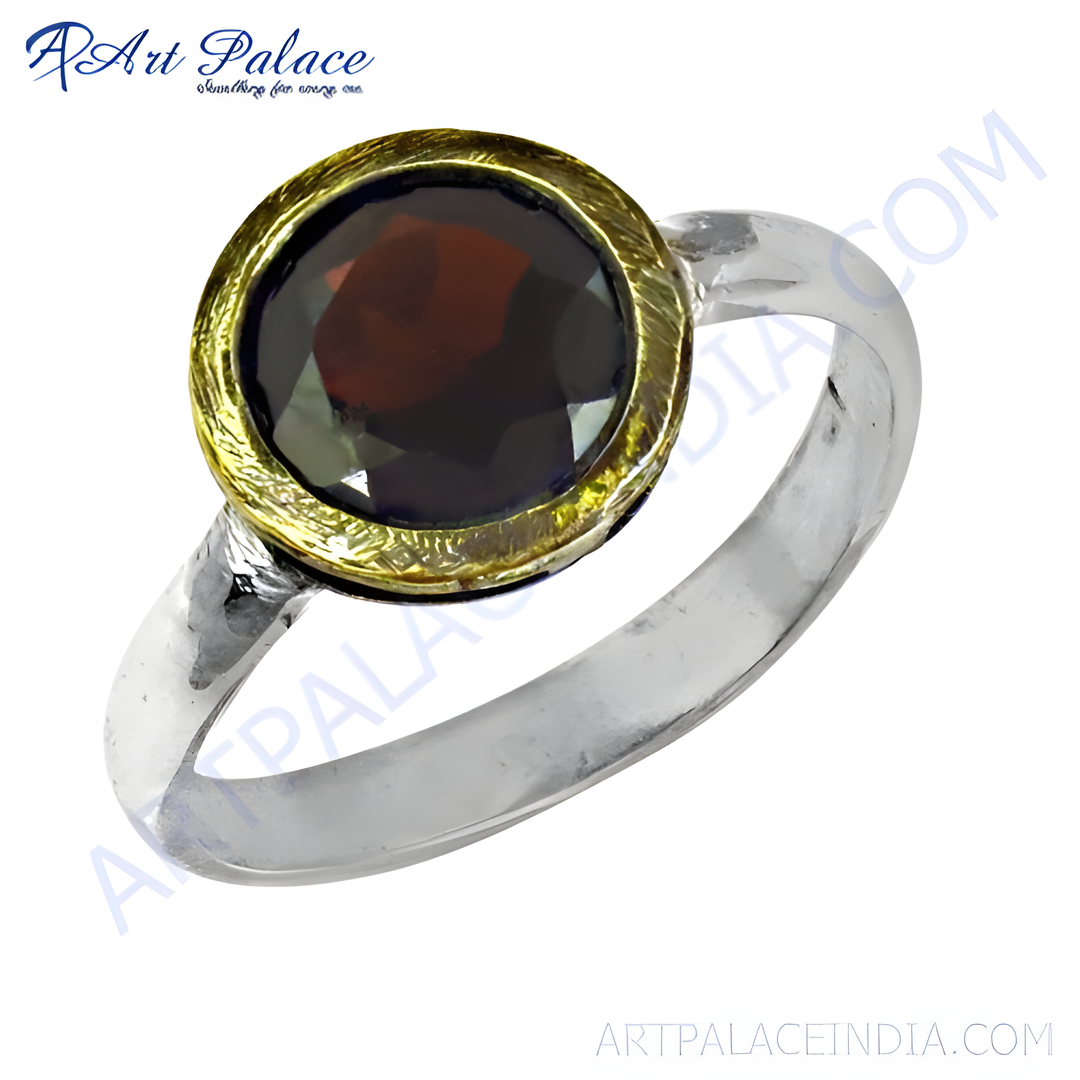 A round red garnet gemstone ring with a gold plating-finished bezel setting and a silver band.