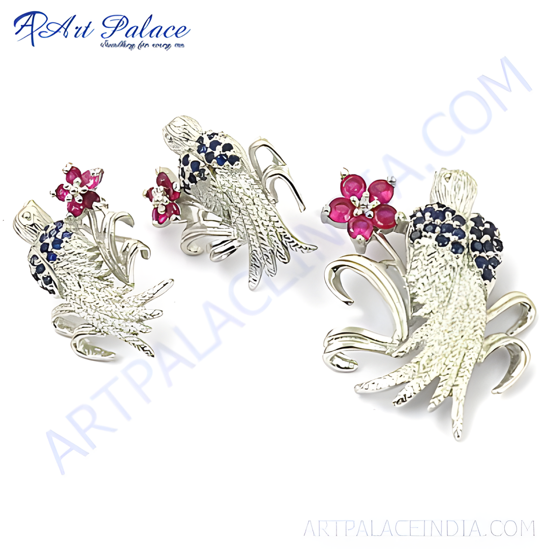 Silver floral stud earrings with ruby and sapphire gemstones.