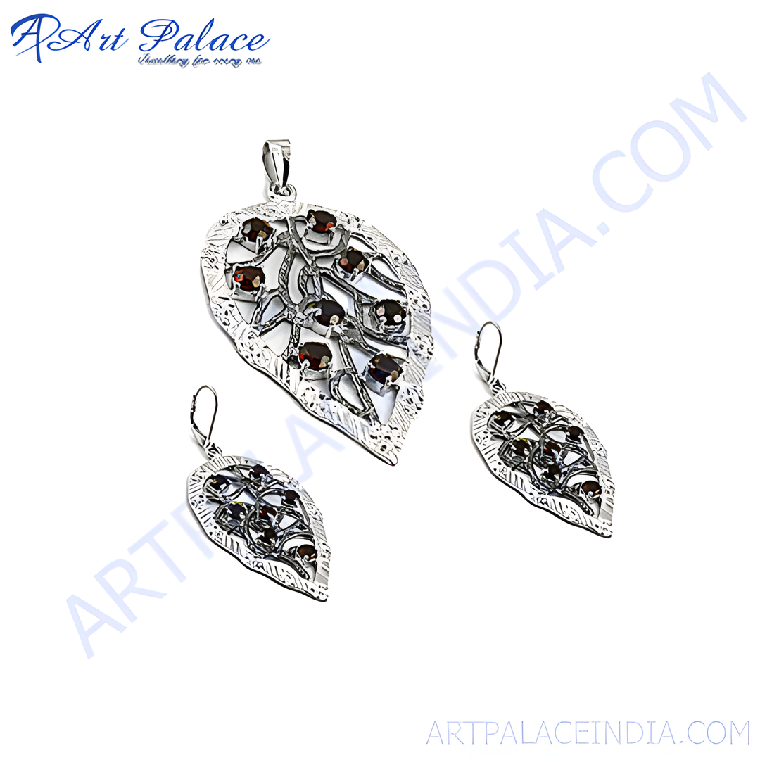 Sterling silver leaf pendant and earrings set with red garnet gemstones for women.