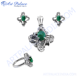 Load image into Gallery viewer, Sterling silver emerald jewelry set, including earrings, a pendant, and a ring, featuring vibrant green gemstones and an elegant floral design.

