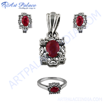 Load image into Gallery viewer, A stunning silver jewelry set featuring a ruby gemstone pendant, matching earrings, and a ring.
