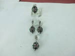Load image into Gallery viewer, Sterling silver jewelry set with gemstone ring, earrings, and pendant featuring emerald, ruby, and onyx stones.
