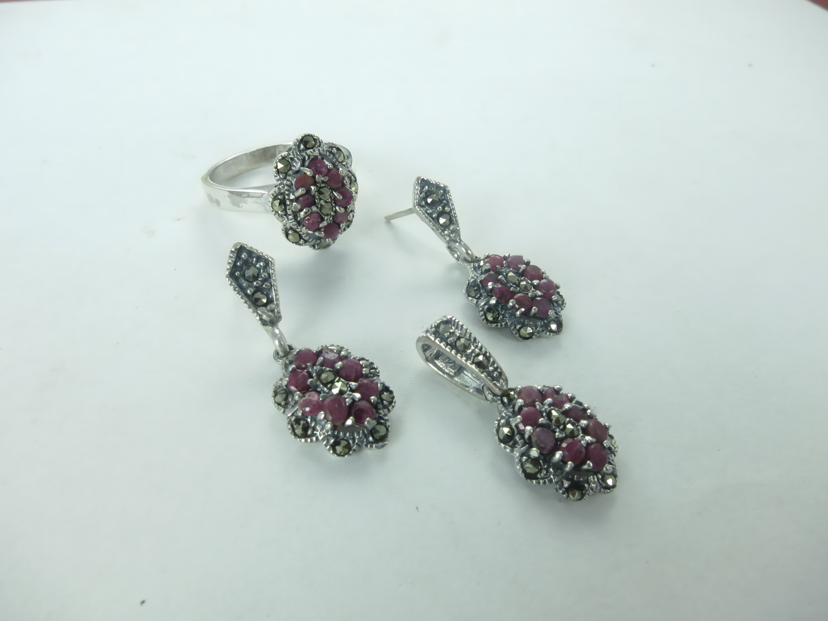 Sterling silver ring and earrings set with ruby gemstones and marcasite detailing