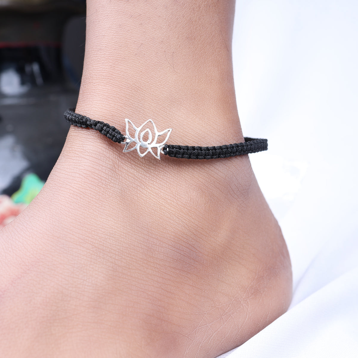 Adjustable black cord bracelet with sterling silver lotus charm