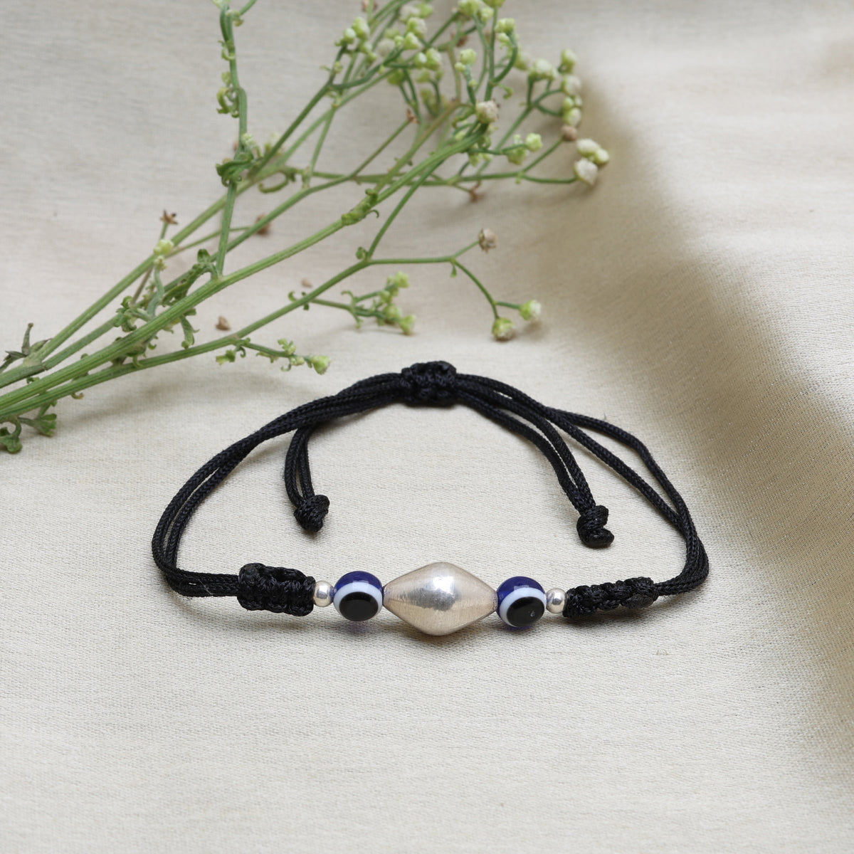 Black cord adjustable bracelet with silver bead and evil eye charms