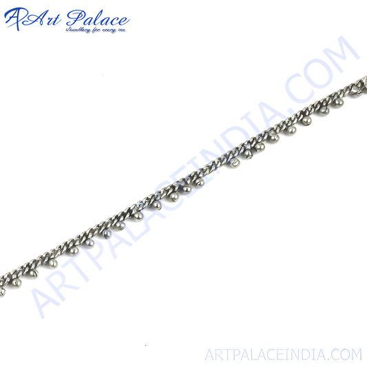 Silver anklet with small decorative beads, delicate chain design for women's feet.