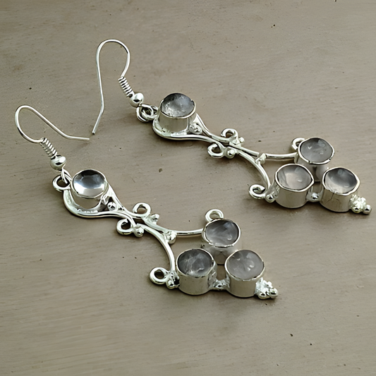Sterling silver dangle earrings with multiple gemstones on a neutral background.
