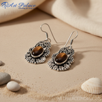 Load image into Gallery viewer, 925 sterling silver dangle earrings with oval tiger eye gemstone center, detailed openwork design, for women.

