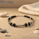 Load image into Gallery viewer, Black onyx beaded necklace with silver accents on a black jewelry display.
