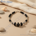 Load image into Gallery viewer, Black onyx bead necklace with sterling silver accents on a black bust
