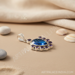Load image into Gallery viewer, 925 sterling silver pendant with a pear-shaped blue topaz center stone and amethyst accents, displayed on a white background.
